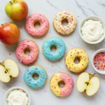 Apple Fruit Donuts topped with colorful cream cheese frosting and sprinkles