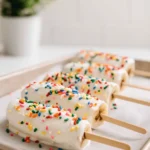 Frozen Yogurt Banana Pops coated in yogurt with rainbow sprinkles