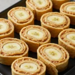 Peanut Butter Banana Roll Ups sliced and served on a plate