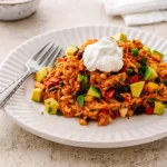 Chicken Burrito Casserole in a baking dish with melted cheese