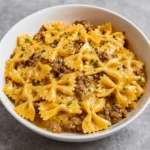 creamy parmesan garlic beef bowtie pasta in rustic bowl