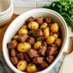 Crockpot Garlic Butter Beef Bites with Potatoes served in a white dish