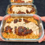 High Protein Creamy Cajun Chicken & Rice plated with creamy sauce and parsley