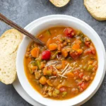 Lentil Minestrone recipe in a rustic bowl with bread