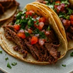Slow Cooked Chuck Roast Tacos on rustic dinner table