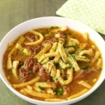 Slow Cooker Beef and Noodles served in a rustic bowl