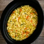 Slow Cooker Chicken Noodle Soup in rustic bowl