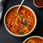 white bean tomato soup in rustic bowl with bread