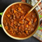 autumn harvest beef stew in Dutch oven with fall vegetables