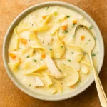 creamy chicken noodle soup in a rustic bowl