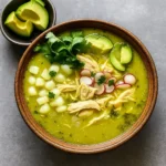 Crockpot Mexican Chicken Pozole Verde served in a bowl with garnishes