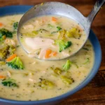 bowl of healthy chicken broccoli soup on table