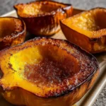 Roasted acorn squash with brown sugar served on rustic table