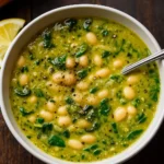 spinach and white bean soup in rustic bowl