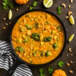 Thai Pumpkin Curry in a bowl with rice and lime